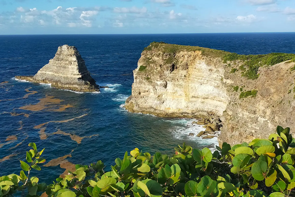 Rocky sea cliffs with deep blue ocean waves.