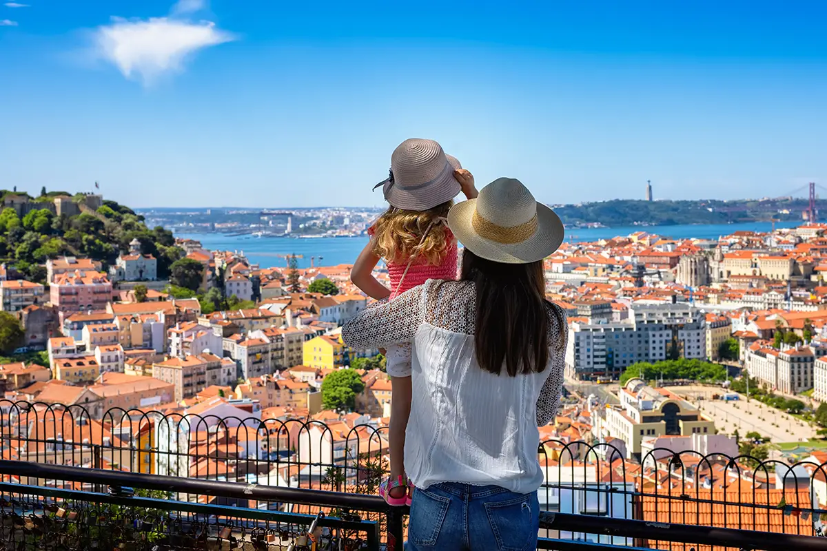 Mother and daughter at a viewpoint in Lisbon, Portugal.